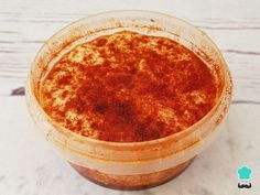 an orange substance in a plastic container on a table