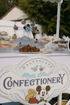 a sign for the disneyland main street confectionery at an outdoor fairground