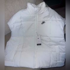 New With Tags. Nike. Puffer Vest. Xl. Fits Very Loose More Like 2xl Nike White Outerwear With Pockets, White Nike Outerwear With Pockets, Nike White Outerwear For Cold Weather, Nike White Winter Outerwear, White Nike Outerwear For Winter, White Cotton Puffer Outerwear, Nike Casual Spring Puffer Jacket, Nike Winter Outerwear, Nike Winter White Outerwear For Fall