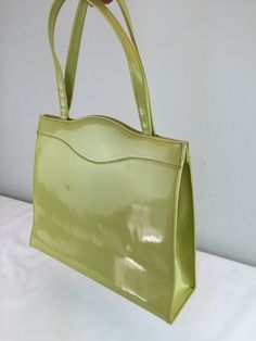 "Circa: 1950s 1960s A rare and most stunning colour! Chartreuse vinyl medium handbag by Lennox. The colour bold and lovely and the closure is spring locked with a little coin purse of rayon to match the interior. Exceptional condition. Why was she not used more than once if at all? They'll think you've loads of money with this sort of stylish handbag DO YOU ACCEPT OFFERS? We do NOT accept offers or negotiate on pricing. We do offer layaways and have sales throughout the year. Shipping overages a Loads Of Money, Air Pillow, Interior Clean, Faux Leather Handbag, Medium Handbags, Vintage Inspired Dresses, Small Storage, Handbag Purse, Banking