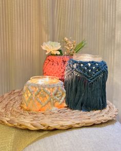 two vases sitting on top of a wicker tray