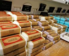 several packages of cheese stacked on top of each other in front of the counter at a store