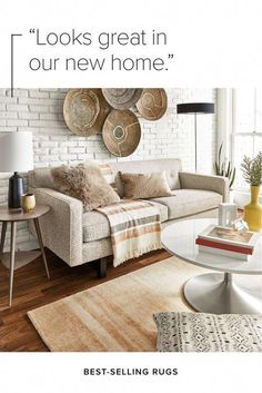 a living room with white brick walls and wooden flooring is featured in this ad