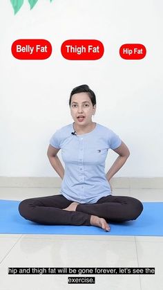 a woman is sitting in the middle of a yoga pose with her hands on her hips