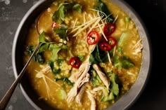 a bowl of soup with chicken and vegetables