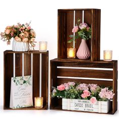 two wooden crates with flowers and candles on them