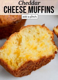 a muffin cut in half on top of a white plate with the words cheddar cheese muffins