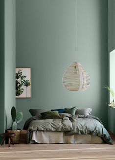 a bedroom with green walls and wooden floors is featured in the instagram post on instagram