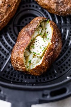 some bread is sitting on top of a black grill grate with cheese and chives in it