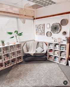 a living room filled with furniture and lots of storage space next to a large window