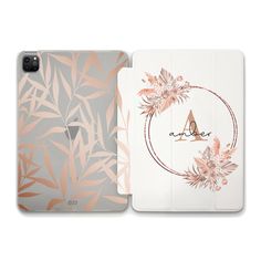 an ipad case with pink flowers and leaves on the front, and a white background