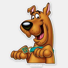 the scooby dog sticker is smiling and holding a toy in its paws