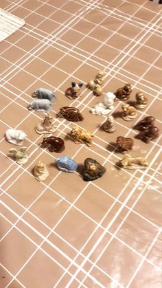 a group of small toy animals sitting on top of a tiled floor