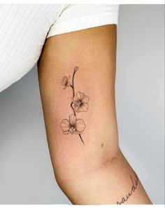 a woman's arm with a flower tattoo on it