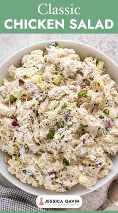 a white bowl filled with chicken salad on top of a table