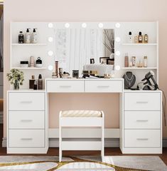 a white vanity with lights on it and a bench in front of the mirror that is open