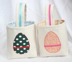 two small bags with designs on them are sitting side by side, one has an egg and the other has polka dots