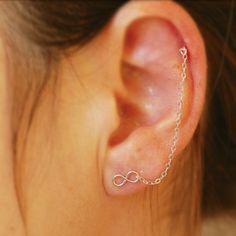 a woman's ear with a chain attached to it