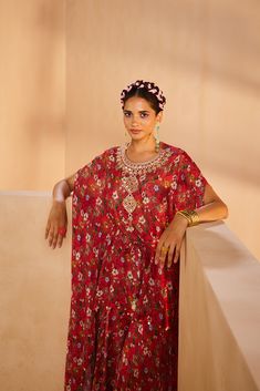 Featuring a floral-printed kaftan and sharara. The kaftan’s neckline is embroidered by hand using a mirror, sequences, and beadwork. The tie-up is accentuated with mirrors and the kaftan hem is accentuated with antique gold coins.From Aneesh Agarwaal's Seher collection.DELIVERY TIMEPlease allow 8-12 weeks for your outfit to arrive.FABRIC DETAILSChinonProfessional cleaning only. Bollywood Style Festive Kaftan With Floral Embroidery, Festive Bollywood Kaftan With Floral Embroidery, Eid Festive Kaftan With Floral Print, Festive Floor-length Floral Print Kaftan, Festive Bohemian Floral Print Kaftan, Traditional Designer Kaftan With Floral Print, Traditional Floral Print Kaftan For Designer Wear, Traditional Floral Print Kaftan For Festivals, Bohemian Red Sharara With Mirror Work