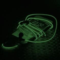 a cell phone that is glowing green in the dark