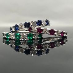 14K White Gold Sapphire and Diamond Band METAL: 14K White Gold TOTAL WEIGHT: 3.3 g DIAMONDS: Natural Round Brilliant Diamonds COLOR: G/H CLARITY: VS2-SI1 TOTAL WEIGHT: 0.40 ct GEMSTONES: Natural Round Brilliant Cut Emeralds FINE QUALITY TOTAL WEIGHT: 0.42 ct SIZE: Ladies 4-8. Please indicate your ring size at checkout. Contact us for all additional sizes. DESCRIPTION: This is a beautiful emerald and diamond band. It has 9 stones total,with diamonds and emeralds alternating. It's classic, prong s Classic Gemstones With Prong Setting, Anniversary Diamond Gemstones With Diamond Cut, Anniversary Diamond Cut Gemstones, Anniversary Diamond With Diamond Cut, Classic Wedding Gemstones With Diamond Cut, Classic Round Multi-stone Jewelry, Brilliant Cut Cubic Zirconia Gemstones For Anniversary, Anniversary Brilliant Cut Cubic Zirconia Gemstones, Classic Round Cut Promise Ring Gemstones