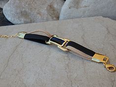 Cream and black leather bracelet. Leather bracelet with gold bar. Enamel bar bracelet. Gold plated leather bracelet. Black & cream bracelet Black and cream leather bracelet, with gold plated and enamel bar. Material: Leather, 24K Gold Plated, Enamel Length:6.8 inches+ 2 inches extra MADE TO ORDER WITH CUSTOM LENGTH. PLEASE WRITE YOUR SIZE IN NOTE The bracelet will be packed in a gift box. FOR MY BRACELET COLLECTION HERE: https://www.etsy.com/il-en/shop/rebekajewelry?section_id=14207851&r Elegant Leather Bracelet With Gold Clasp, Adjustable Gold Leather Bracelet Chic Style, Adjustable Gold Leather Chic Bracelet, Gold Minimalist Leather Bracelet, Minimalist Gold Leather Bracelet, Adjustable Leather Bracelet With Gold Clasp, Elegant Rectangular Bracelets With Leather Strap, Gold Leather Bracelet As Fashion Accessory, Elegant Rectangular Bracelet With Leather Strap