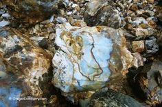 some rocks and gravel on the ground with one rock sticking out of it's center