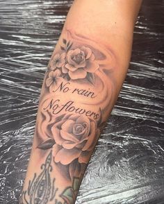 a woman's leg with roses and the words no rain, no flowers on it