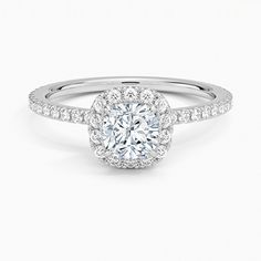 a round brilliant cut diamond ring with pave set shoulders