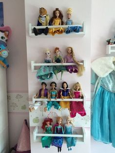 there are many princess dolls on the shelves