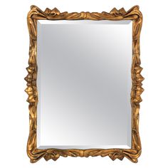 an ornate gold framed mirror on a white background