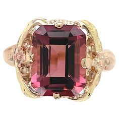 Vintage 10K gold filigree ring with applied rose gold flowers and green gold leaves featuring an emerald cut pink tourmaline. This beautiful orangy pink, pomegranate color tourmaline weighs 3.80 carats and measures about 10mm x 8mm. The ring fits a size 7 finger, weighs 1.65dwt and dates from the 1940's. Pomegranate Color, Rose Gold Flowers, Filigree Ring Gold, Rose Gold Flower, Vintage Cocktail Ring, Pink Tourmaline Ring, Gold Leaves, Tourmaline Ring, Gold Filigree