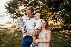 a man and woman holding two small children