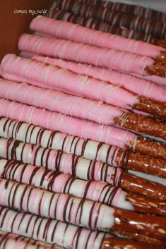 there are many pink and white candy canes lined up