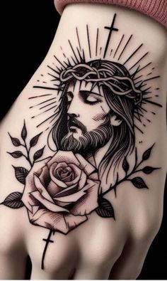 a hand with a rose and jesus on it