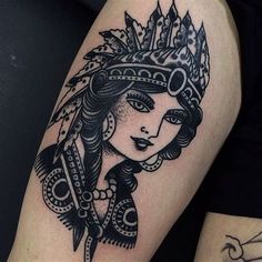 a woman with a crown on her head is sitting next to another woman's leg