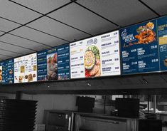 the menus are hanging on the wall above the counter