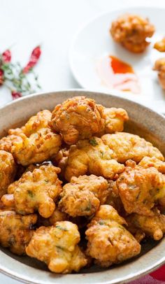 a bowl filled with fried food on top of a table