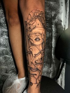 a woman's leg with a tattoo on it