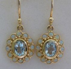 These elegant Women's Vintage Sky Blue Topaz and Opal earrings are simply stunning ! Crafted in 9ct Solid Yellow Gold with reference to a vintage design these luxurious Oval cut NATURAL Sky Blue Topaz's have been bezel set and inlayed with 24 NATURAL Opals set by a Master Jeweller ! These pair of GORGEOUS Victorian Inspired earrings have 9ct Gold French Hook Wires attached and will make a great heirloom set to be treasured for a lifetime THESE EARRINGS ARE READY MADE AND AVAILABLE TO SHIP NEXT D Victorian Earrings, Gold Topaz, Earrings Antique, Sky Blue Topaz, Topaz Earrings, Antique Earrings, Opal Earrings, Jewellery Designs, Earrings Vintage