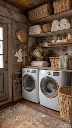 a washer and dryer in a small room with baskets on the shelves above