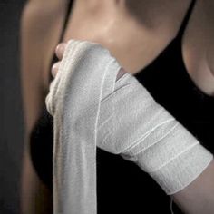 a woman with an arm cast wrapped around her thumb