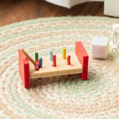 a wooden toy train set sitting on top of a rug