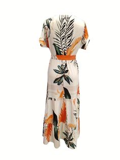 Blooming with tropical vibes, this dress is a perfect choice for those who love to embrace bold prints and vibrant colors. The dress showcases a beautiful tropical print with lush green and orange leaves, making it ideal for summer gatherings and vacation adventures. Its round neckline and short sleeves offer a relaxed and comfortable fit, while the waist tie provides a flattering silhouette by highlighting your waist. The tiered skirt adds a playful touch and ensures ease of movement. Made from Vacation Adventures, Lace Embroidery Dress, Dress Elegant Short, Crew Neck Dress, Orange Leaves, Tropical Print Dress, Tropical Leaf Print, Floor Length Dress, Crewneck Dress