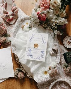 a table topped with lots of different types of flowers and paper on top of it