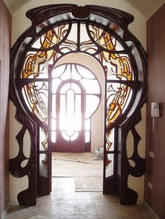 an open door leading to a large stained glass window