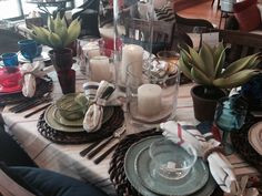 the table is set with dishes and place settings