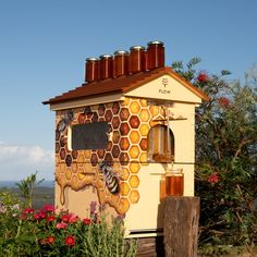 a beehive with honey jars on top of it