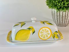 a ceramic dish with lemons and leaves painted on it