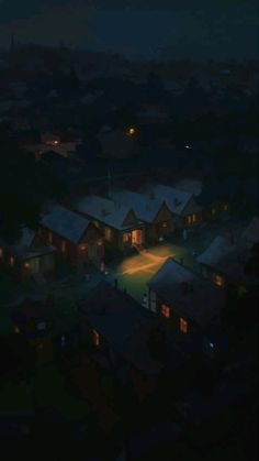 an aerial view of houses lit up at night